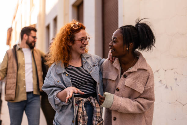 istock Group of friends smiling and walking 1391393948