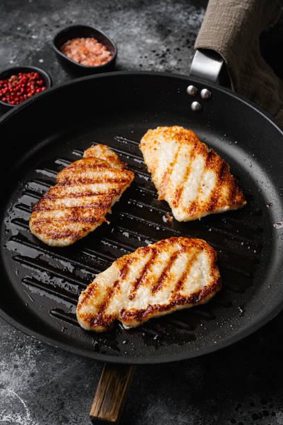 istock Pork  meat schnitzel, on black dark stone table background 1391396709