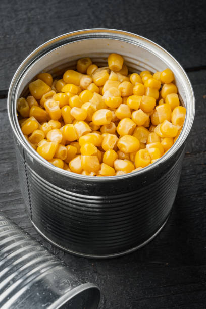 istock Canned sweet corn, on black wooden table background 1391397491