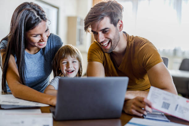 istock Happy family watching something on a computer at home. 1391398577