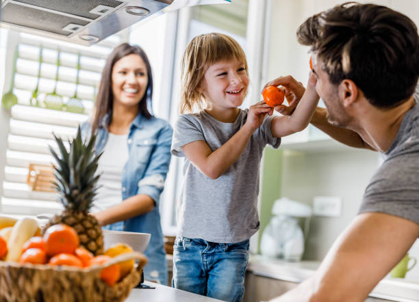 istock Happy boy having fun with his father in the kitchen. 1391398914