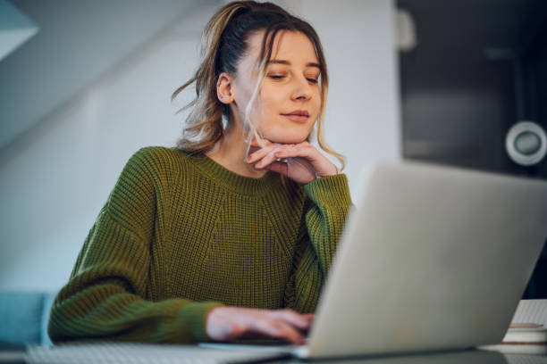 istock Woman working from a home on her a laptop 1391399066