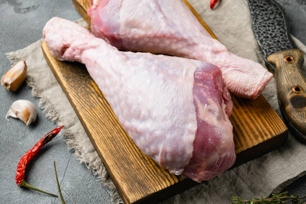 istock Turkey drumstick fresh meat, on wooden cutting board, on gray stone table background 1391400214
