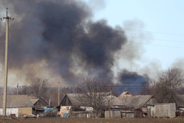 Thick black smoke over the village.  War in Ukraine. Thick black smoke over the village. Fire in the village. War in Ukraine. ukrainian village stock pictures, royalty-free photos & images