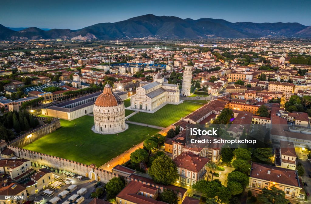 Leaning Tower of Pisa - Aerial View Aerial view of famous Leaning Tower of Pisa and Cathedral Santa Maria surrounded by the illuminated cityscape of Pisa at dusk. Piazza dei Miracoli, Tuscany - Italy Pisa Stock Photo