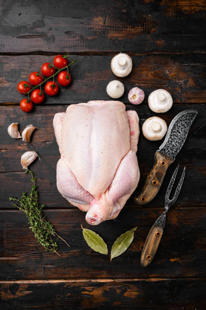 istock Whole raw chicken, on old dark  wooden table background, top view flat lay 1391402622