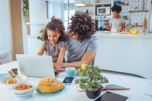 istock Happy father with kid laughing watching funny video on laptop 1391402697