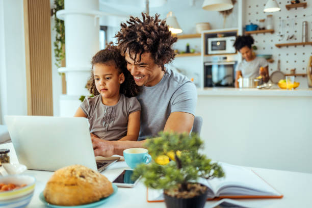 istock Father and daughter Having fun with laptop at home 1391402733