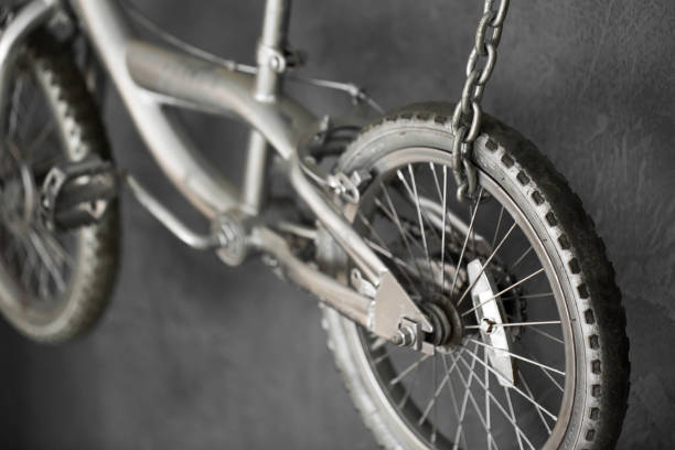 istock Silver bike hanging on chains against the wall in the Studio. 1391403013