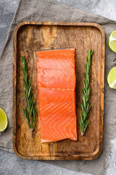 istock Fresh salmon steak, with herbs, on gray stone table background, top view flat lay 1391403663