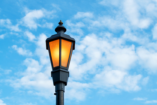 Street lamp against blue sky and clouds