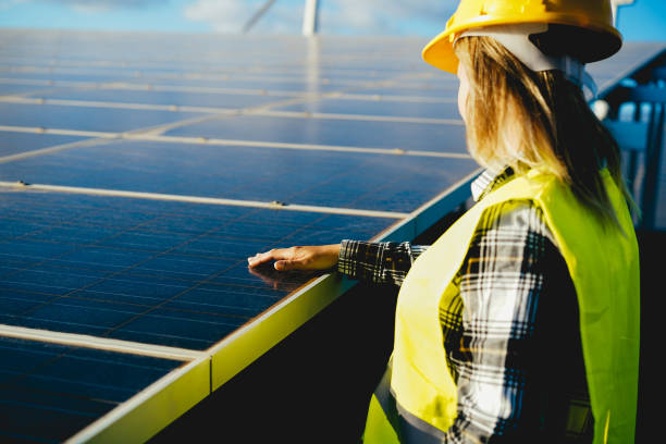 istock Engineer woman working at alternative energy farm - Focus on hand over solar panel 1391407150