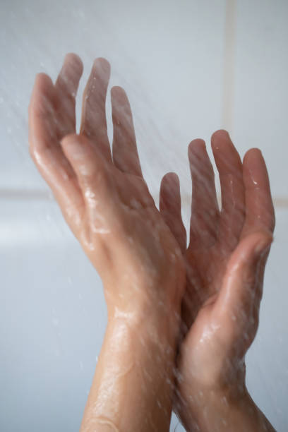 istock Female hands touching the water in bathroom 1391409757