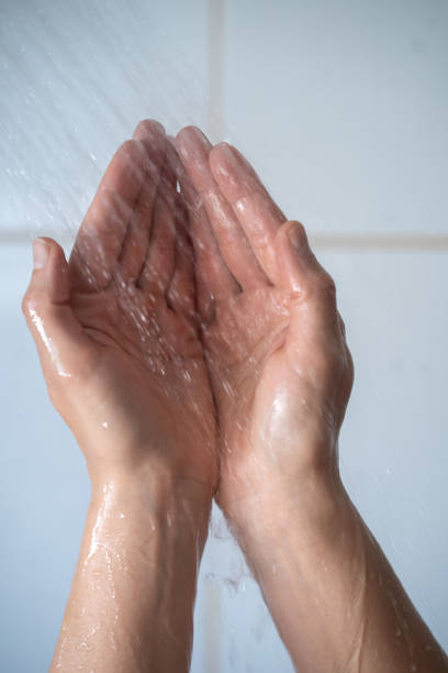 istock Female hands touching the water in bathroom 1391409758