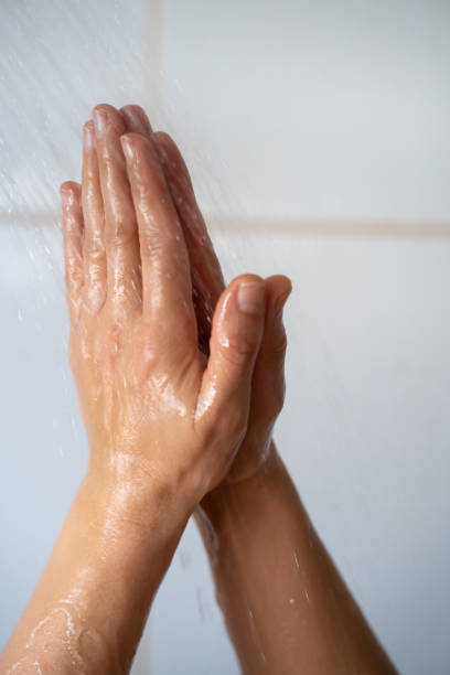 istock Female hands touching the water in bathroom 1391409763