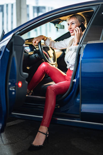 istock Woman talking on mobile phone while sitting in car 1391409770