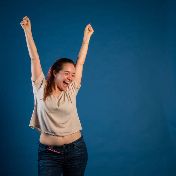 istock Young enthusiastic woman screaming with joy 1391410893
