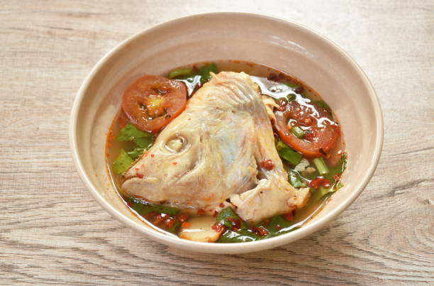 istock boiled red tilapia fish wit tomato and herb in tom yum soup 1391411563