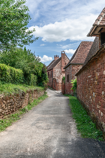 Street with perfectly preserved medieval residential masonry buildings on outskirts of Collonges-la-Rouge. Correze department, New Aquitaine region, France