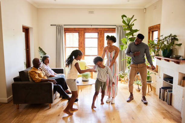 istock Multi-generation family having fun dancing together at home 1391412262