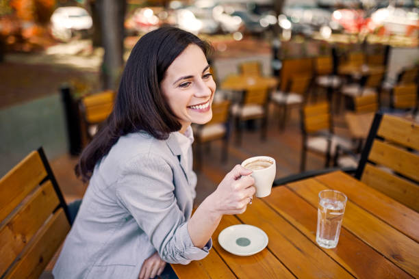 istock Young Caucasian woman sitting drinking coffee 1391413111