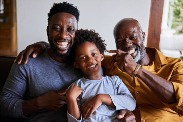 istock Man and his senior dad and young son laughing while sitting at home 1391415220