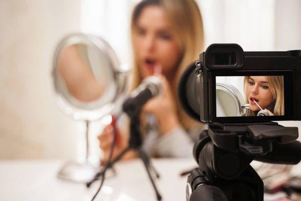 istock Modern mirrorless camera recording video of beauty blogger's make-up routine 1391415476