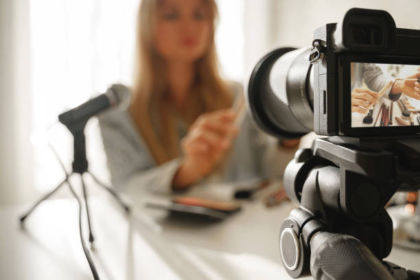 istock Modern mirrorless camera recording video of beauty blogger's make-up routine 1391416076