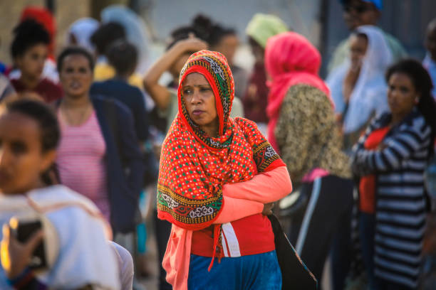 Local Young Woman in Bright scarf standing on the Asmara Street Asmara, Eritrea - November 02, 2019:  Local Young Woman in Bright scarf standing on the Asmara Street eritrea stock pictures, royalty-free photos & images