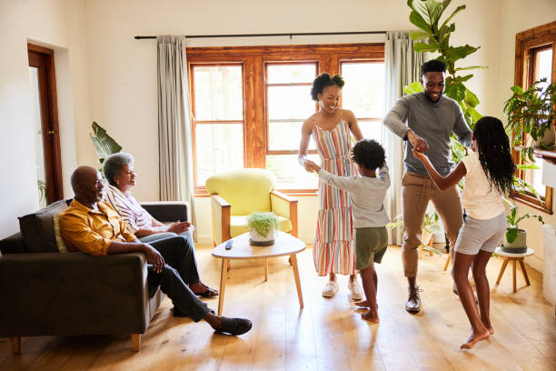 istock Laughing multi-generation family dancing together at home 1391416342