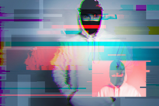 Creative image with anonymous hacker with glitch and interference effects. Concept of cybersecurity.