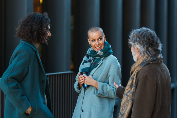 istock Business people talking while relaxing on a break from work outdoors on the street. 1391423541