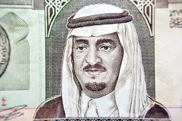 A portrait of Fahd Bin Abdulaziz Al Saud, the former king of Saudi Arabia kingdom from the obverse side of 1 one Saudi Arabia riyal money banknote bill, vintage retro old money, selective focus