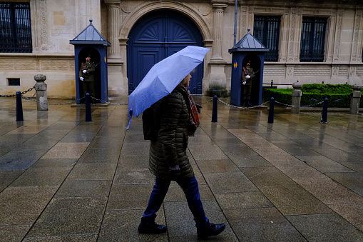 Pedestrians hold umbrellas during a rainfall in Luxembourg on April 8, 2022.