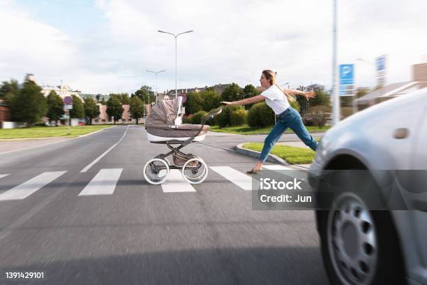 Inconsiderate Mother Trying To Catch Her Baby Pram Rolled Out On The Road Stock Photo - Download Image Now