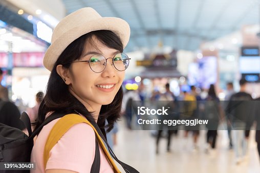 istock Asian Woman traveler wearing glasses at the airport 1391430401