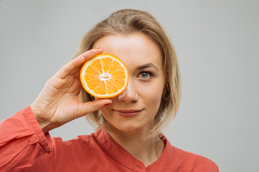 portrait with half an orange, natural beauty and care