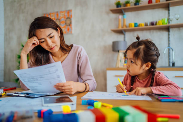 istock Worried mother going through her financials 1391441252