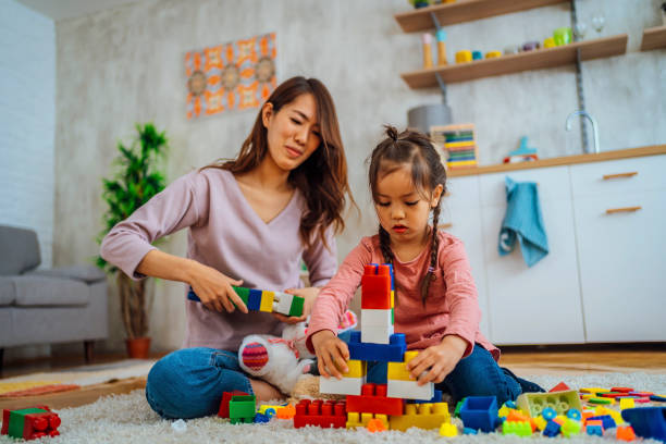 istock Mother and daughter playing with construction toys 1391441765