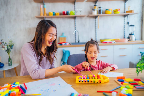 istock Mom and daughter are learning musical instruments 1391441977