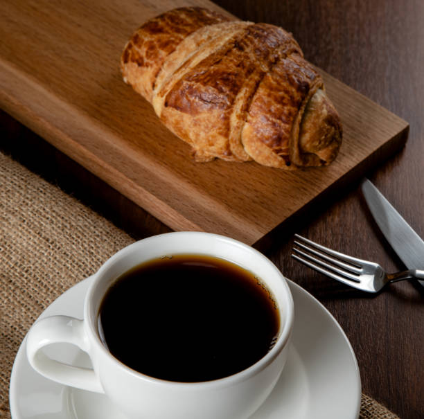 istock Croissant with a cup of full coffee,directly above 1391444655