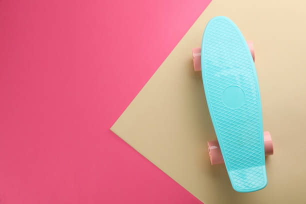 istock Turquoise skateboard on color background, top view. Space for text 1391446035