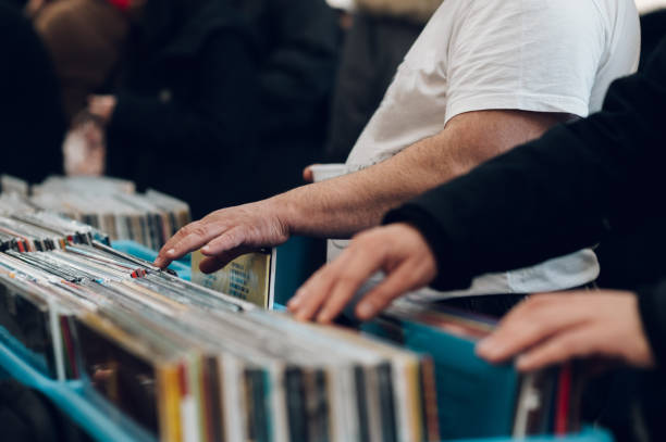 istock Man hands browsing vinyl album in a record store 1391448215