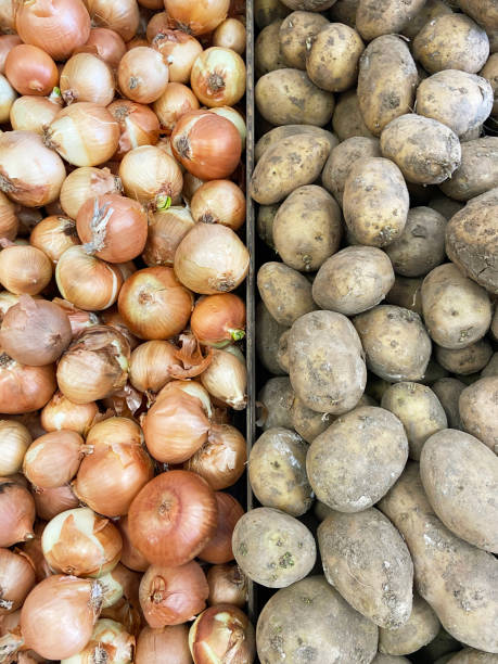 istock Onions and potatoes side by side on the market stall 1391448721