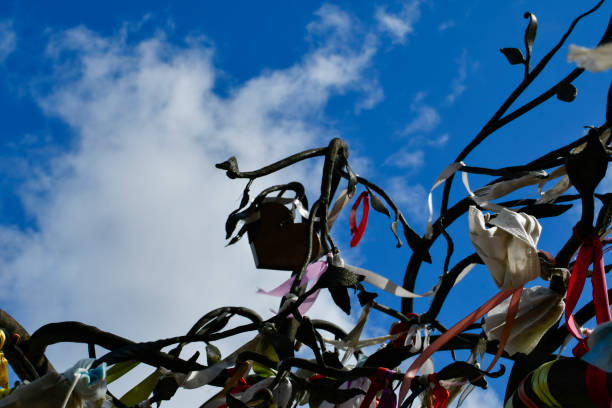 istock Many multi-colored ribbons develop in the wind. Making wishes. A sunny day. 1391449940