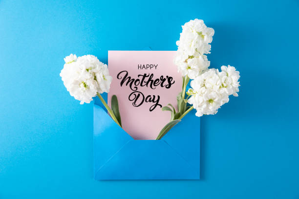 istock White Flowers with White Greeting Card in Blue Envelope 1391450564
