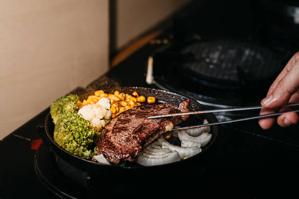 Chef cooking beef steak in the kitchen