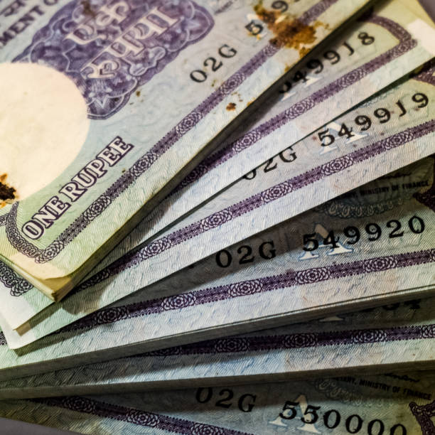 istock Old One Rupee notes combined on the table, India money on the rotating table. Old Indian Currency notes on a rotating table, Indian Currency on the table 1391451916