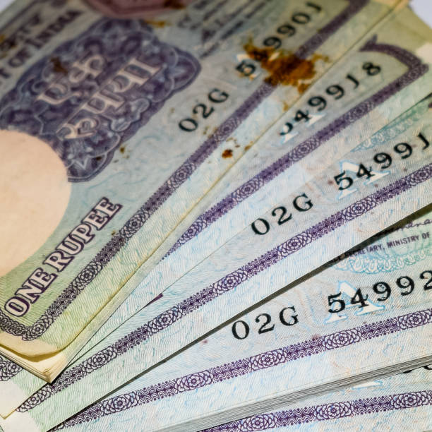 istock Old One Rupee notes combined on the table, India money on the rotating table. Old Indian Currency notes on a rotating table, Indian Currency on the table 1391451920