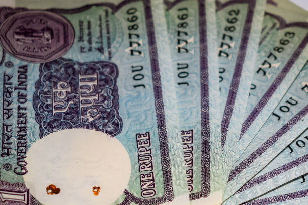 istock Old One Rupee notes combined on the table, India money on the rotating table. Old Indian Currency notes on a rotating table, Indian Currency on the table 1391451927